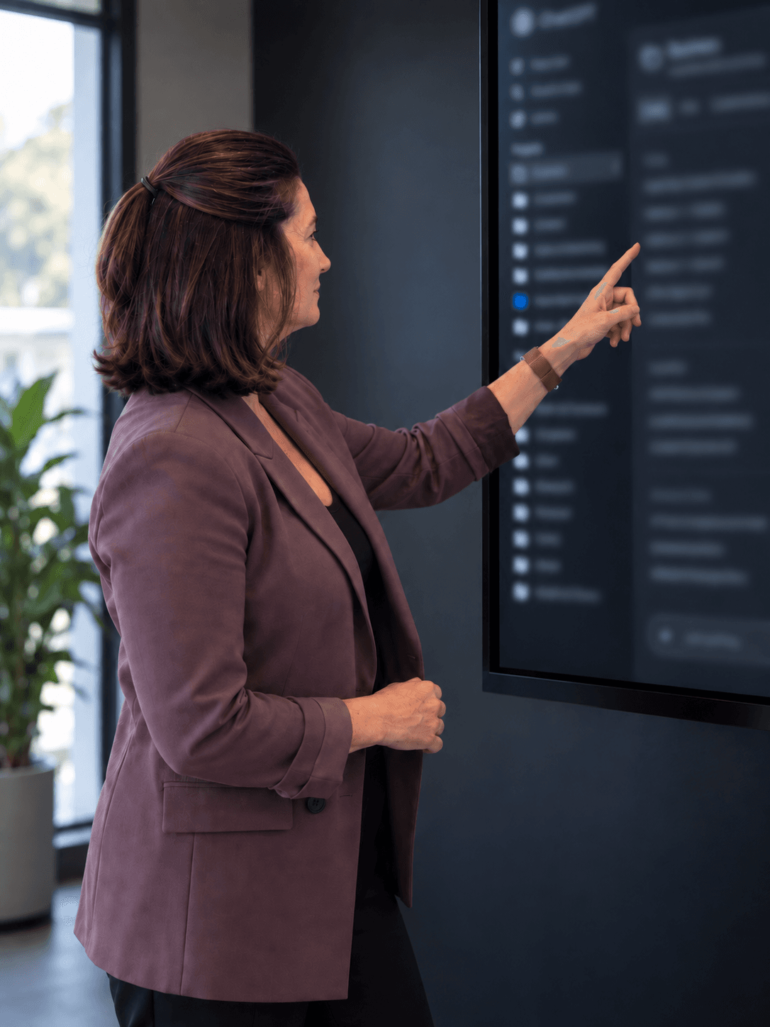 Linda Cunningham pointing at an AI workspace on a screen